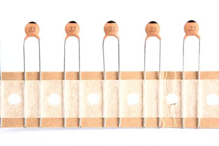 New ceramic capacitors on paper tape isolatet on white.の写真素材