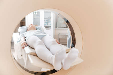 Medical CT or MRI Scan with a patient in the modern hospital laboratory. Interior of radiography department. Technologically advanced equipment in white room. Magnetic resonance diagnostics machineの写真素材