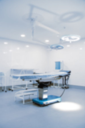 Blurry empty interior operating room and modern equipment in hospital.Medical device for surgeon surgical emergency patient in blue tone style.Save life medical treatment conceptの写真素材
