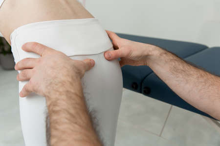 Back massage. Chiropractor or osteopath fixing back during visit in manual therapy clinic. Doctor doing shoulder blade therapy. Scoliosis. Posture Correction. Chiropractic treatment, Back pain reliefの写真素材