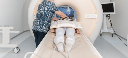 Doctor or nurse and patient with tomography CT or MRI Scan in hospital. Interior of radiography...