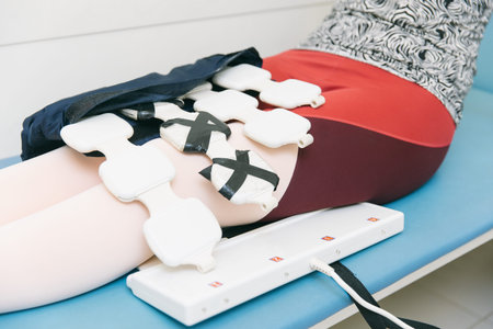 Woman in clinic at the treatment of pressure therapy procedure for legs. Device to provide...