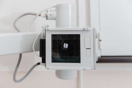 Hospital Radiology Room. X-ray department in modern hospital. Medical equipment. scan machine for fluorography. Technician adjusting an xray machine. Scanning chest, heart, lungs in modern clinic.の写真素材