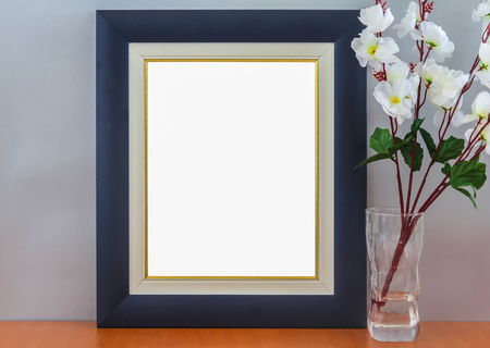 Empty Modern Blue Frame On Wooden Shelf With Vintage Box and Small Boat Modelの写真素材