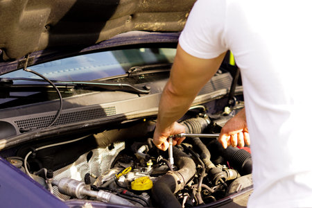 repairman is fixing the car engine