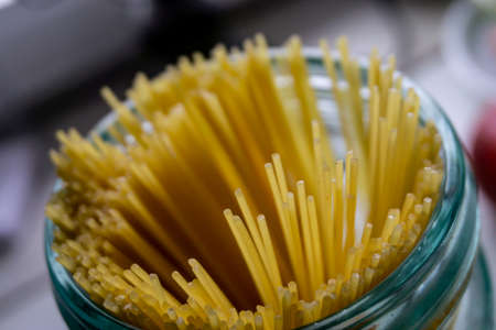 Raw spaghetti in a glassの写真素材