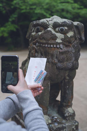A large-faced koma-inu and a charm at Sakurai Shrine in Itoshima City, Fukuoka Prefecture. Sakurai Shrine in Itoshima City, Fukuoka Prefectureのeditorial素材