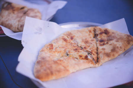 A pizza with ingredients wrapped inside at Dahab, a diving resort on the Red Sea in the Sinai Peninsula, Egypt.の写真素材