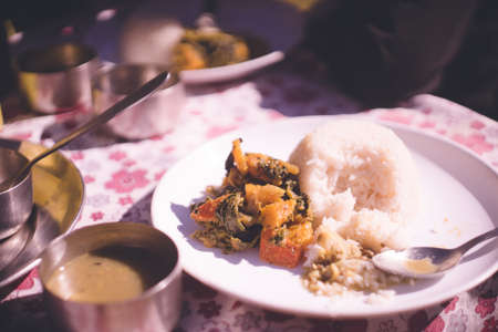 All-you-can-eat set meal of typical Nepali home cooking, "Dal bhat" which includes curry, vegetables and other side dishes, and pickles.の写真素材