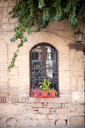 Old window and ancient wall with lamp and flowers in Turkeyの写真素材