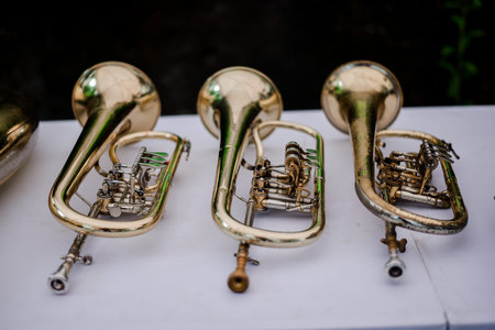 Old brass trumpets on a white table. Musical instrument for orchestra.