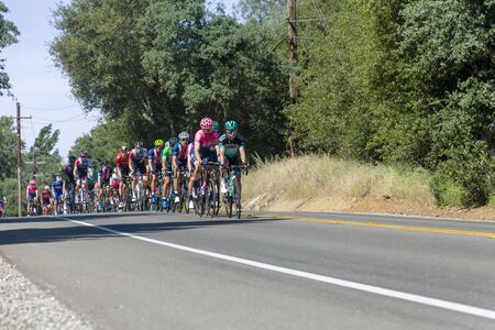 Amgen, Tour of California, SACRAMENTO, CA âMay 13, 2019: Amgen, Tour of California race is on itâs way to South Lake Tahoe, California during stage 2 from Rancor Cordova, California.  In the image the peloton is working itâs way on Bass Lake Road inのeditorial素材