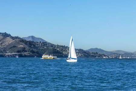 Sailing San Francisco Bay, SAN FRANCISCO, CA - DECEMBER 10, 2017: The image is of a sail boat sailing in the San Francisco Bay near the Marina District Harbor.の写真素材