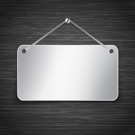 Blank metallic tablet hanging on dark brushed metallic wall.  illustrationのイラスト素材