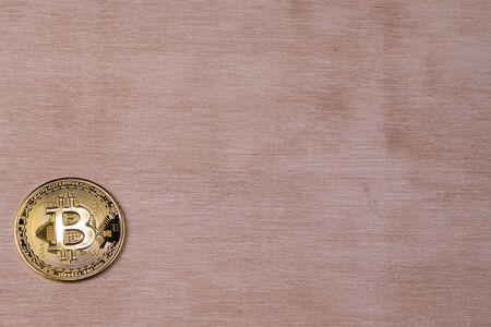 Bitcoin gold coin on white wood table 02 Copyspace for your important messages.の写真素材