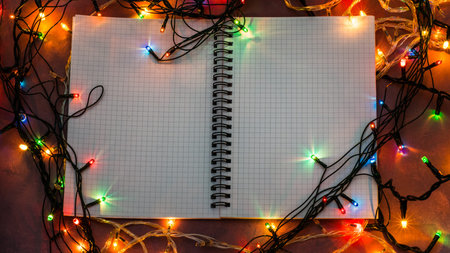 Notebook on a desk. Lights around. Love and devotion.