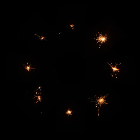 Eight sparklers, burning on black background. Perfect as an overlay of celebration films. Easily inserted into any video for Christmas, New Year etc. Not an animationの写真素材