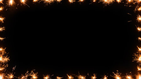 Christmas and New Year party sparklers on black background with space for text. A frame made of sparklers. Excellent addition to your holiday, birthday, Christmas and New Yearの写真素材