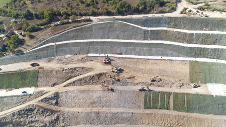 Aerial view of the construction site of a new road on a sunny day