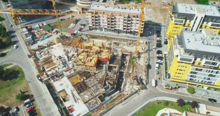 Aerial view of a construction site with cranes and building materials
Construction site. Parking....