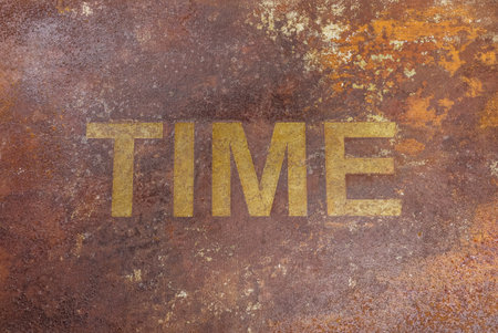Rusty plate metal word TIME steel. Time text on rusty metal background. Time concept.の写真素材