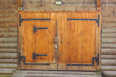 antique large double-leaf gate made of wood with wrought iron hinges close-up of the Russian writer AP Chekhov in the Melikhovo estate, Russia, September 2020のeditorial素材