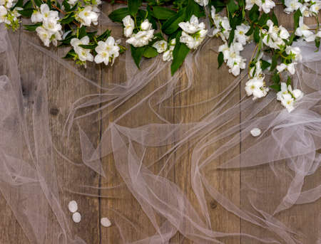 background place for text on a wooden background with a white grid and fresh white jasmine flowersの写真素材