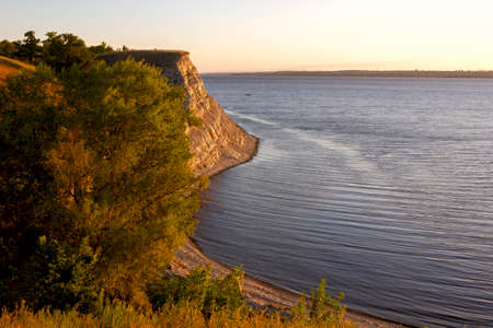 Dawn on the Volga. Beautiful cliffs by the river in the morning rays of the rising sun at golden hourの写真素材