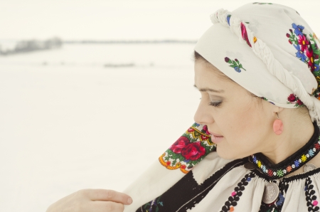 Woman in traditional ukrainian cloth on snowの写真素材