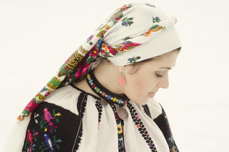 Woman in traditional ukrainian cloth on snowの写真素材