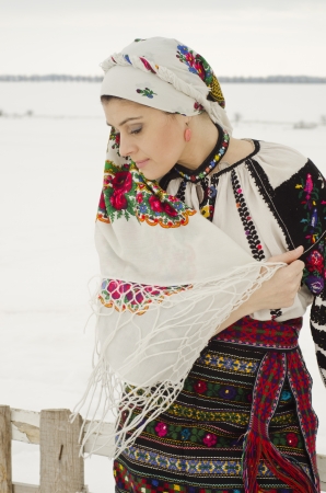 Woman in traditional ukrainian cloth on snowの写真素材