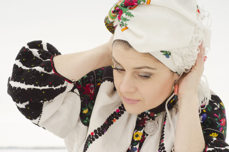 Woman in traditional ukrainian cloth on snowの写真素材