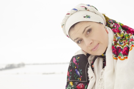 Woman in traditional ukrainian cloth on snowの写真素材