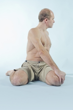 Portrait of strong man sitting in yoga poseの写真素材