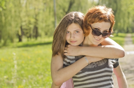 Portrait of mother and daughter in parkの写真素材