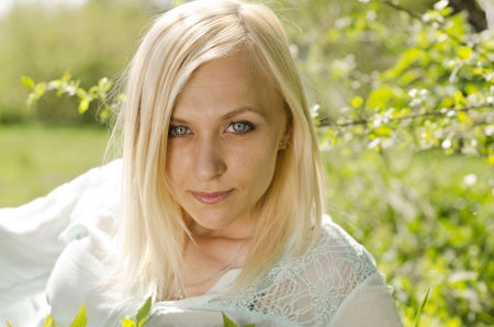 Portrait of beautiful blonde girl in parkの写真素材