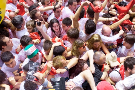 PAMPLONA, SPAIN -JULY 6: People are having fun at the opening of the San Fermin festival. Plaza in front of municipality. Pamplona, Navarra, Spain 6 July 2012 in Pamplona Spain.のeditorial素材