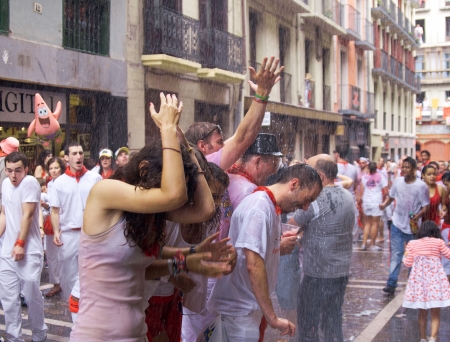 PAMPLONA, SPAIN -JULY 6: Young people having fun at the opening of the San Fermin festival in the street Estafeta. . Pamplona, Navarra, Spain 6 July 2012 in Pamplona Spain. Noonのeditorial素材