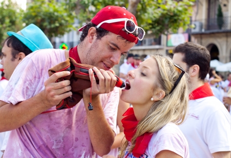 PAMPLONA, SPAIN -JULY 6: Young people having fun at the opening of the San Fermin festival in plaza Castilio. Pamplona, Navarra, Spain 6 July 2012 in Pamplona.のeditorial素材