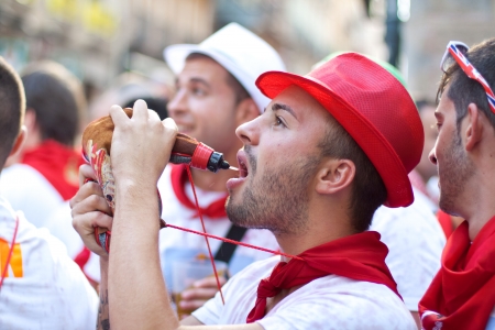 PAMPLONA, SPAIN -JULY 8: Young people having fun at the opening of the San Fermin festival in plaza Castilio. Pamplona, Navarra, Spain 8 July 2012 in Pamplona.のeditorial素材