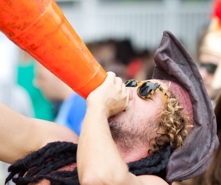 RIO DE JANEIRO - FEBRUARY 11: A man with a traffic cone in hand having fun on free people's carnival in Rio de Janeiro February 11, 2013, Brazil. Av. Vieira Souto along Ipanema Beachのeditorial素材