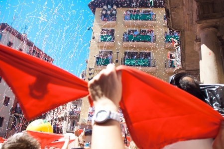 PAMPLONA, SPAIN -JULY 6: People are having fun at the opening of the San Fermin festival. Plaza in front of municipality. Pamplona, Navarra, Spain 6 July 2013のeditorial素材