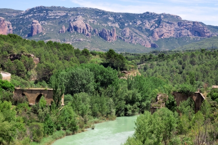 Ruins of old bridge over river Gallego. The autonomous region Aragon, Spain.の写真素材