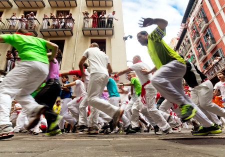 PAMPLONA, SPAIN-JULY 13: People run from the bulls on the street during San Fermin festival in Pamplona, Spain on July 13, 2013..のeditorial素材