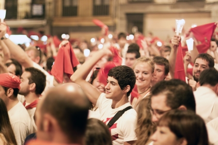 PAMPLONA, SPAIN-JULY 15: People with red handkerchiefs at closing of San Fermin festival. Plaza Consistorial in front of municipality. Pamplona, Navarra, Spain July 15, 2013のeditorial素材