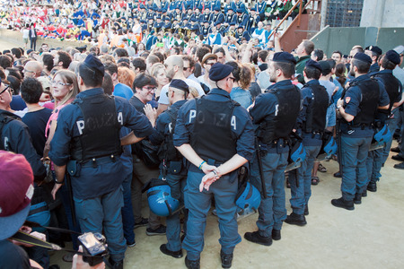 SIENA, ITALY - AUGUST 16: Police keep order before start of annual traditional Palio di Siena horse race in medieval square "Piazza del Campo" August 16, 2014 in Siena, Italyのeditorial素材