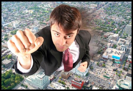 free flying business man power moving over the city belowの写真素材