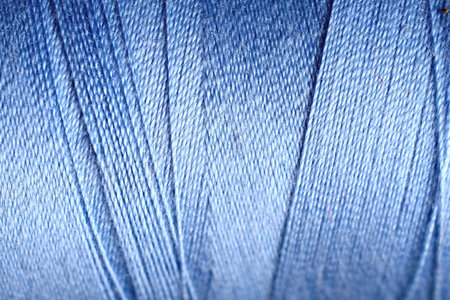 blue thread fabric wool yarn wrapped in a spool of threads and textiles great for a background