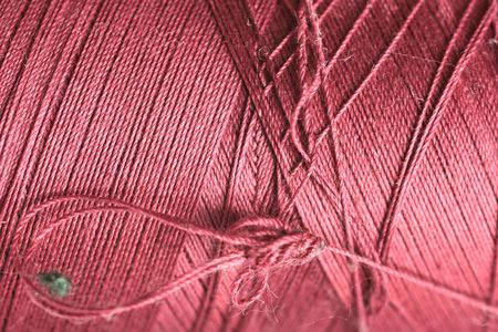 purple thread fabric wool yarn wrapped in a spool of threads and textiles great for a backgroundの写真素材