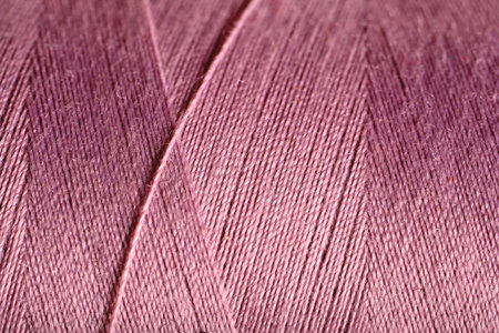 purple thread fabric wool yarn wrapped in a spool of threads and textiles great for a background
